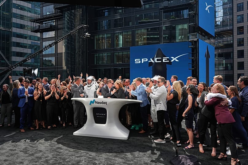 FILE. Employees celebrate during a closing bell ceremony for the IPO of SpaceX at the Nasdaq MarketSite in New York, 12 June 2026