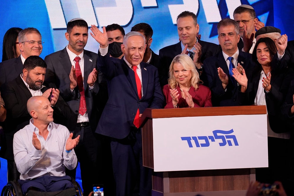 Israeli Prime Minister Benjamin Netanyahu waves to supporters following the release of the first exit poll results in Israel's general election, Wednesday, Oct. 28, 2026. 