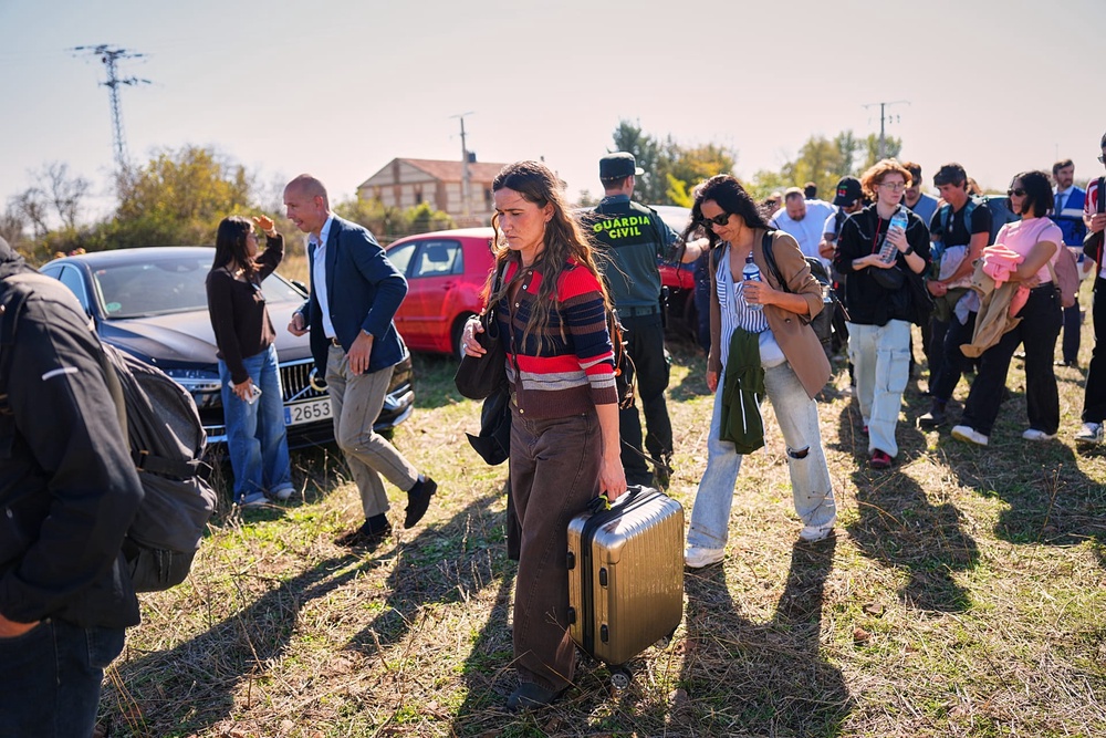 Passengers rescued from one of the trains involved in a collision arrive at a safe area in Urda, Spain, on Wednesday 28 October 2026. (AP Photo/Manu Fernández)