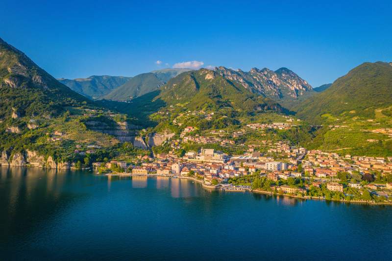 Image from: In Italy, this village famous for its olive groves offers incredible views of a lake and the lush mountains beyond