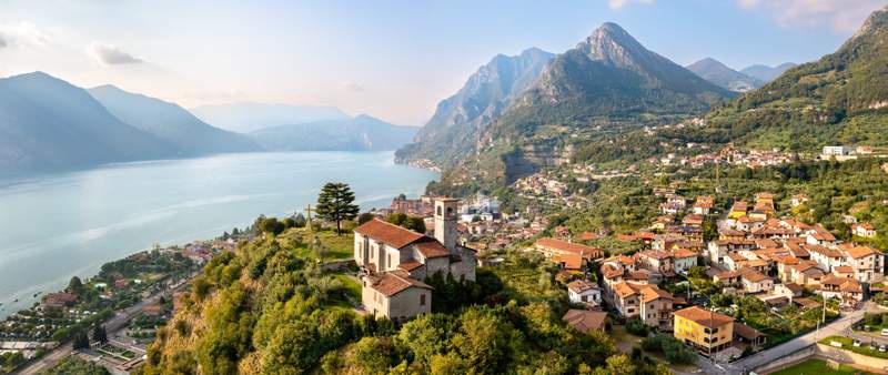 Image from: In Italy, this village famous for its olive groves offers incredible views of a lake and the lush mountains beyond