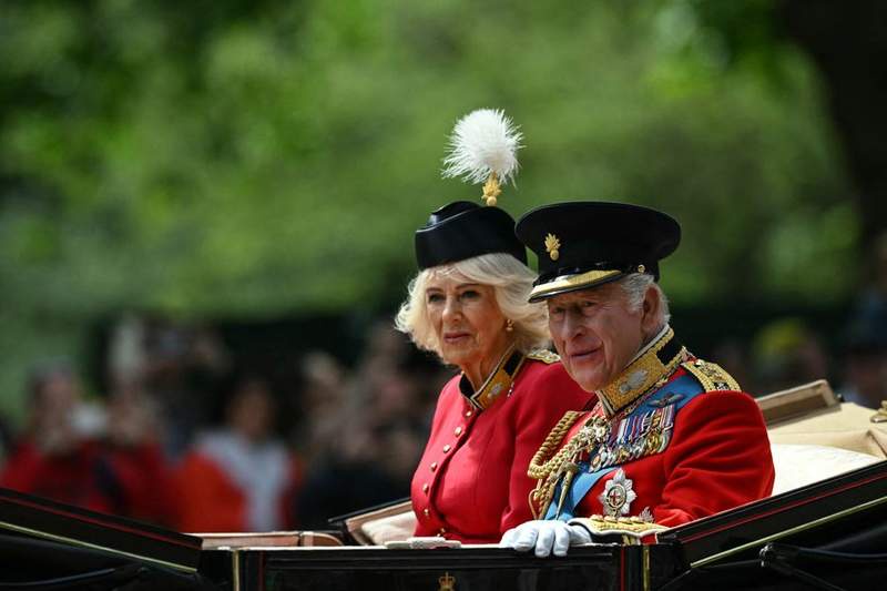 Image from: Queen dons black beret with white feather as she celebrates King's official birthday
