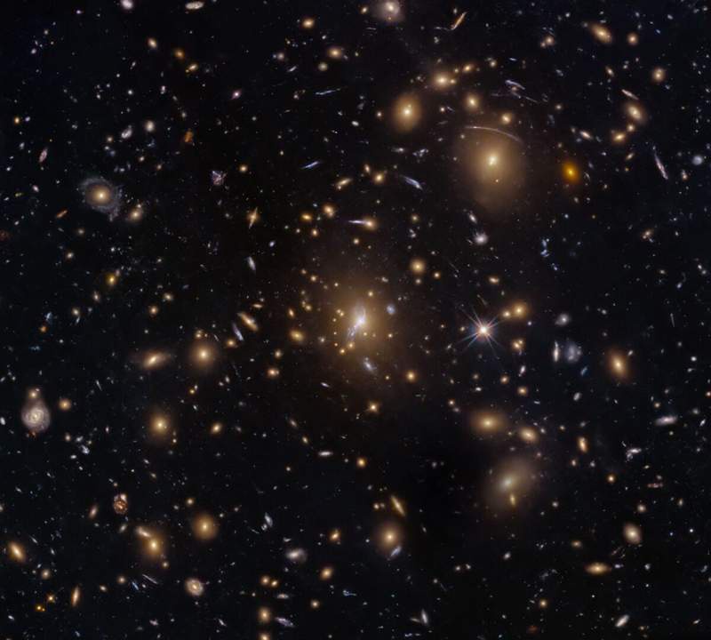 Image from: Hubble Captures A Cosmic Swarm That Is Bending Light Across The Universe