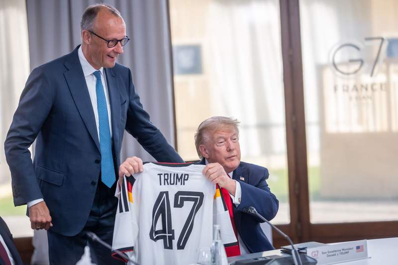 Image from: Muted reaction from Trump as Merz gifts him German team jersey at G7