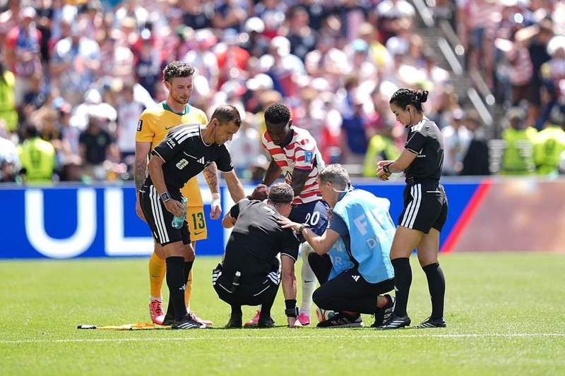 Image from: Referee goes down injured with cramp at World Cup - 'He needs the bucket and sponge'