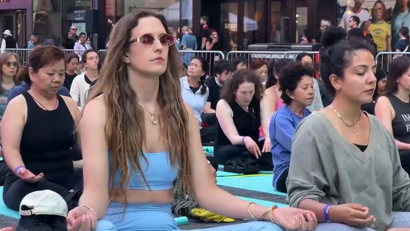 Image from: US: Om chants echo across Times Square in New York on International Yoga Day