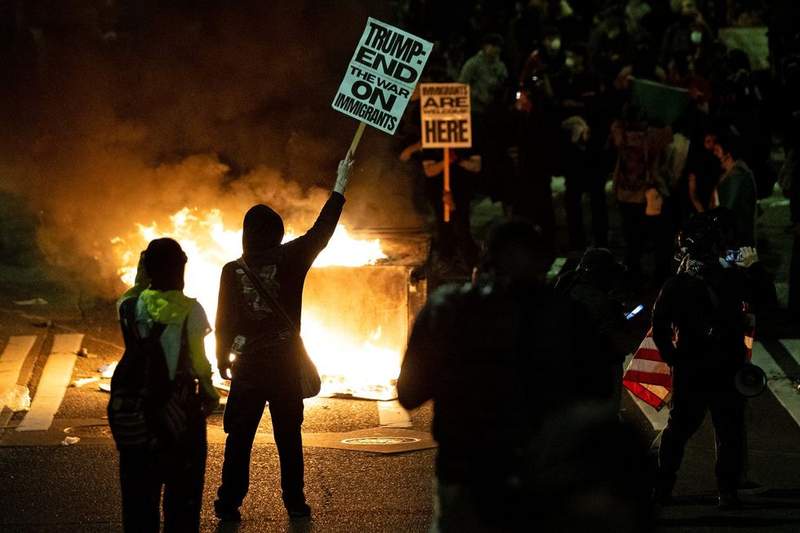 Image from: Police probe after veteran, 80, 'surrounded and knocked to ground' by furious anti-Ice protesters
