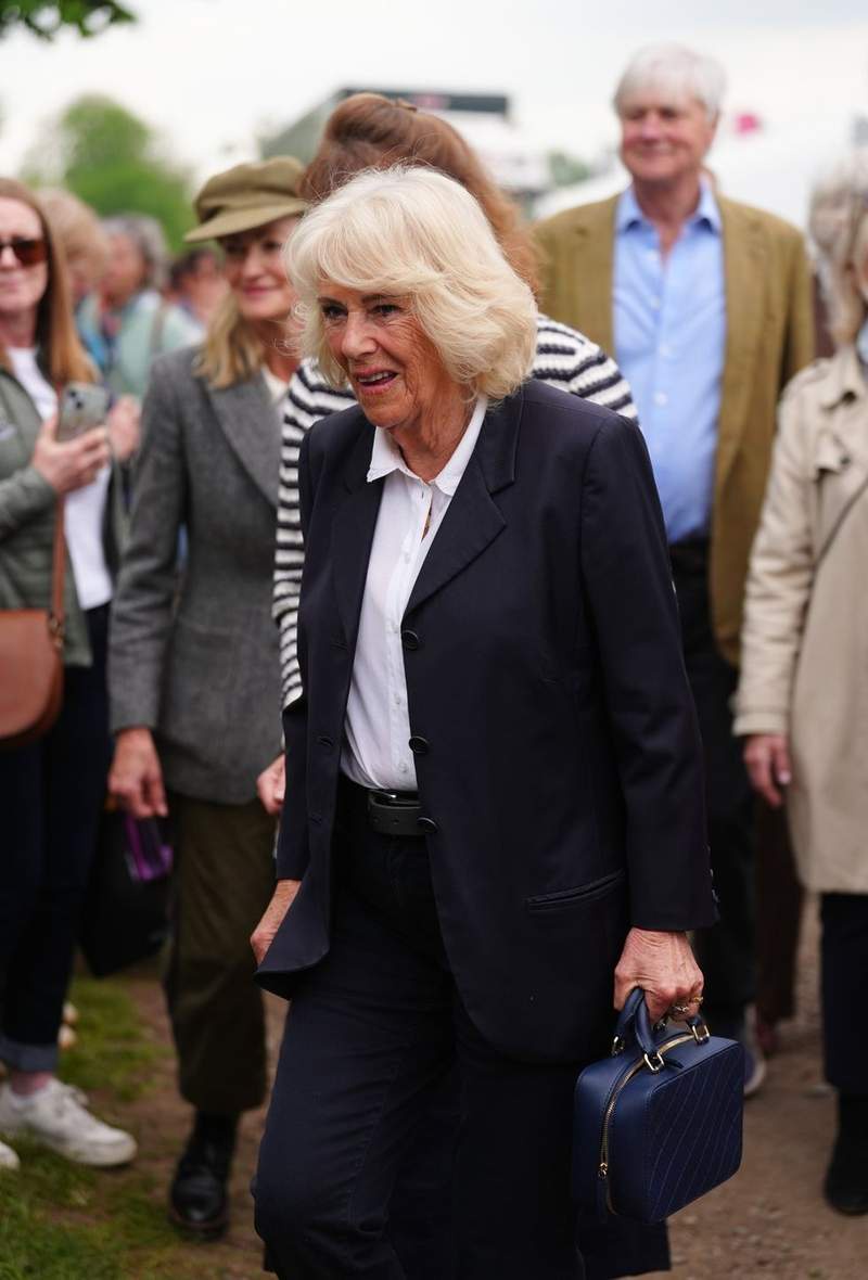 Image from: Queen Camilla breaks tradition as she swaps dresses for trousers