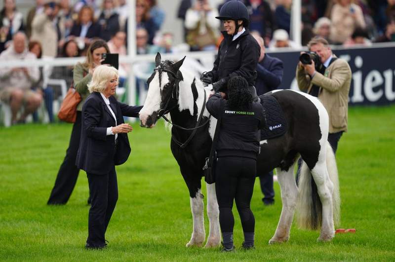Image from: Queen Camilla breaks tradition as she swaps dresses for trousers