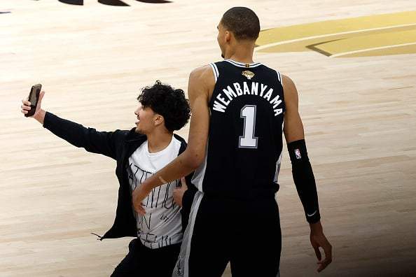 Image from: NBA announces lifetime ban for fan who ran onto Finals court for selfie with Victor Wembanyama