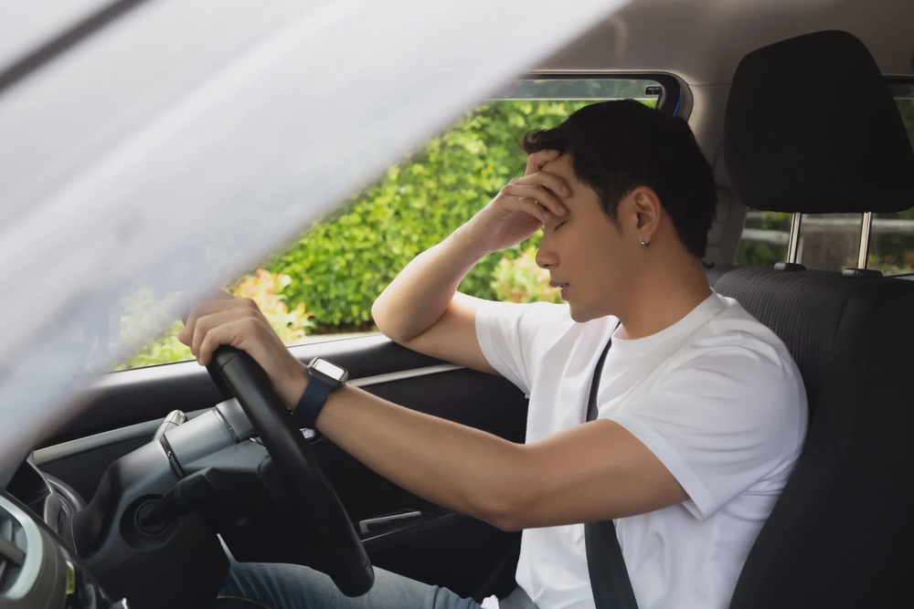 Man driving headache unhappy 123rf