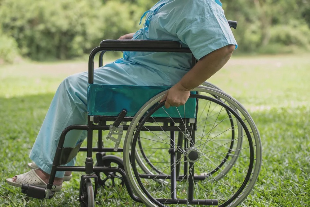 close up lonely elderly woman sitting wheelchair garden hospital 1150 4374