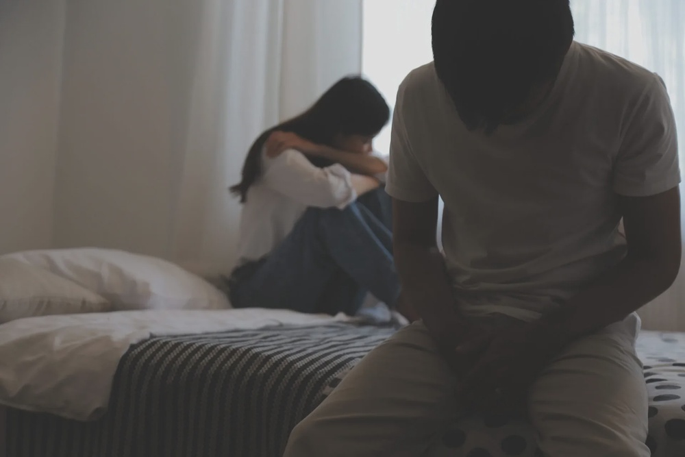 couple unhappy bed sitting 123rf