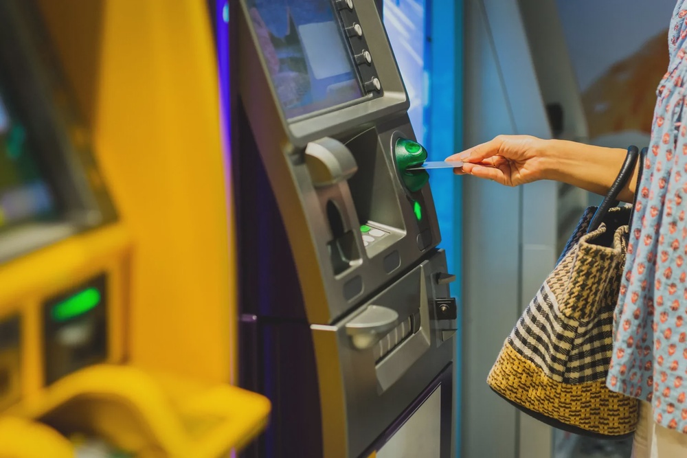 woman insert bank card atm 123rf
