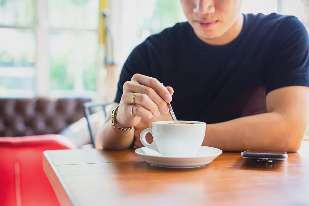 young man use small spoon coffee cup 1150 14261