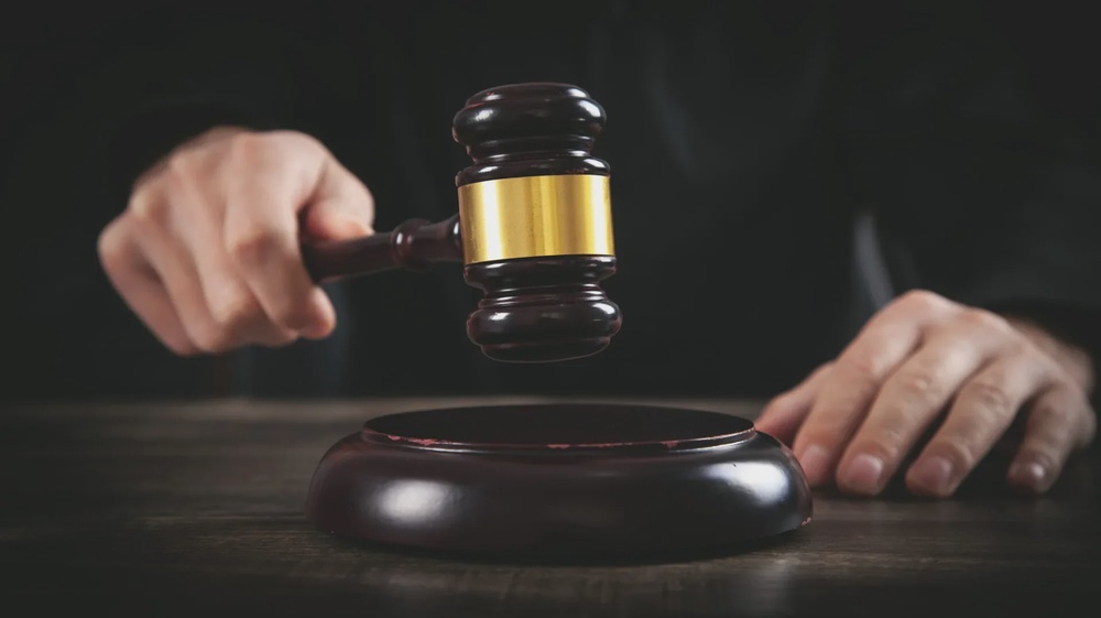 Male judge in a courtroom striking the gavel