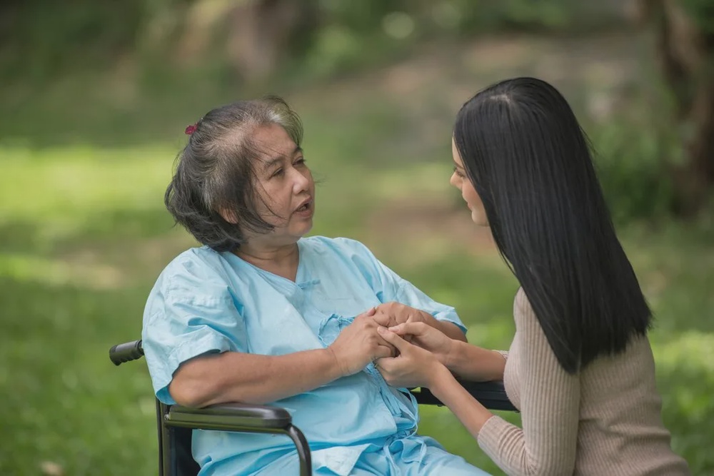 granddaughter talking with her grandmother sitting wheelchair cheerful concept happy family 1150 4363