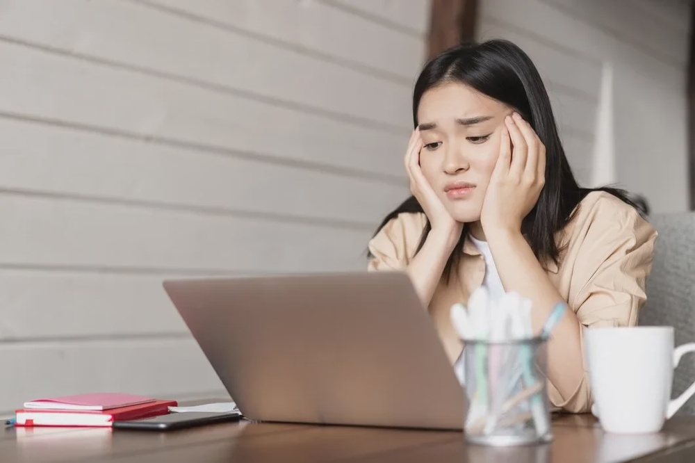 sad bored young asian girl student studying looking upset laptop screen attend boring online 1258 84175