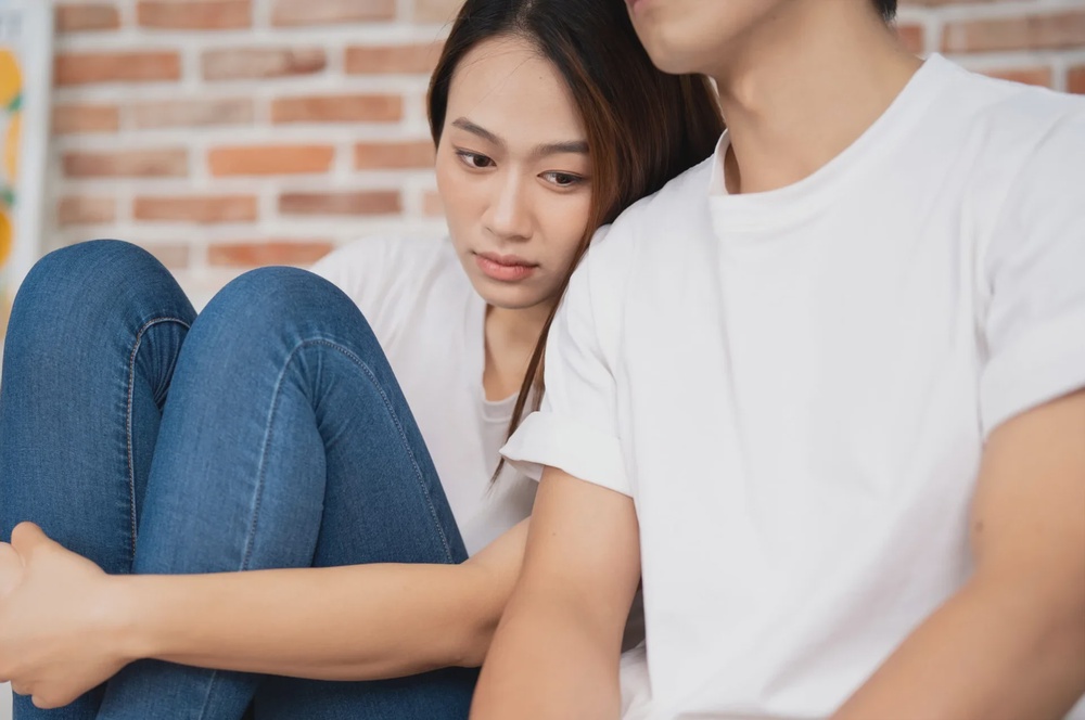 woman man sitting unhappy confused 123rf