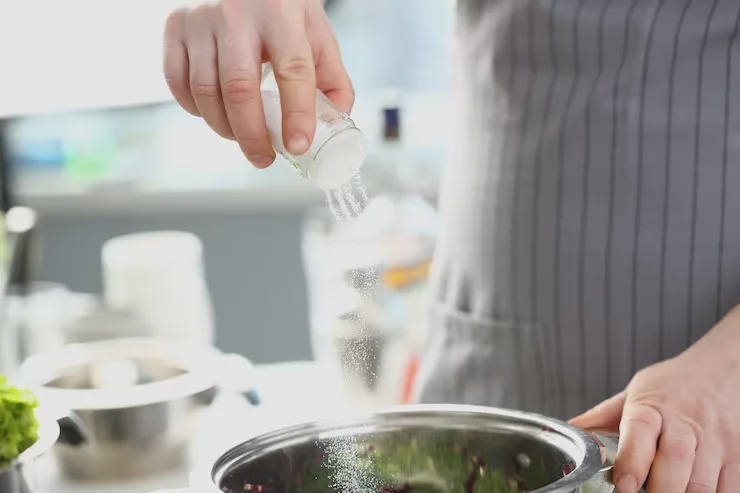 adding seasoning powder salt into food powder cooking