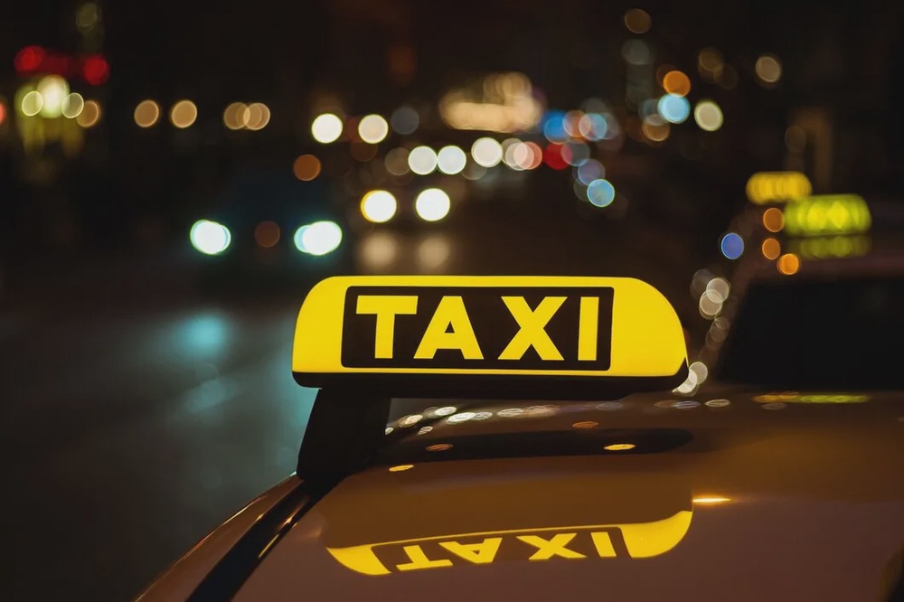 yellow black sign taxi placed top car night 181624 10624