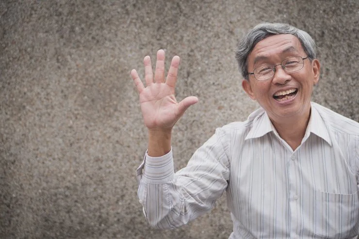 happy old man pointing up five fingers 46728 879 1