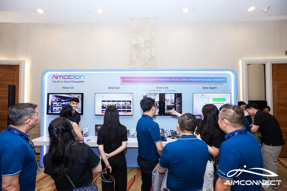 Visitors at the Aimotion AI agents booth during AIMCONNECT 2026