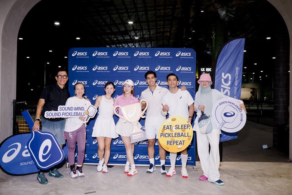 Winners of the World Pickleball Day doubles match celebrating with the ASICS trophy
