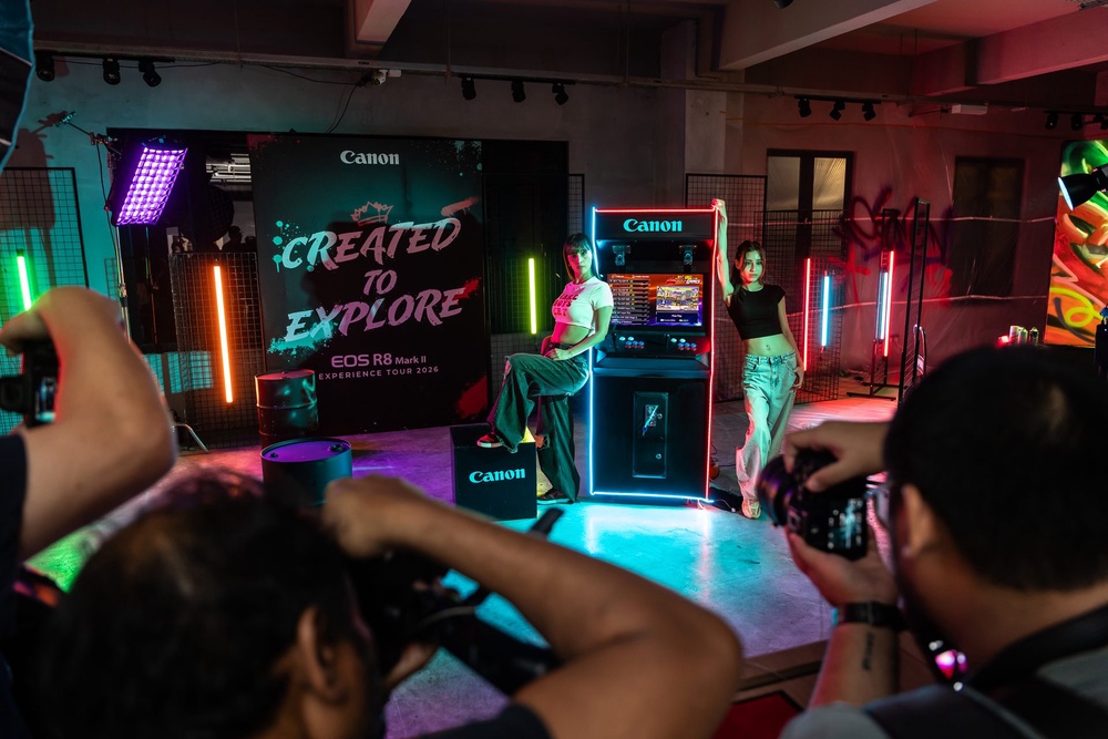 Attendees photograph models at the EOS R8 Mark II Experience Tour portrait set