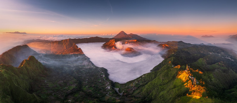 Sunrise panorama of Mount Bromo volcano above a sea of clouds by Le Hong Ha