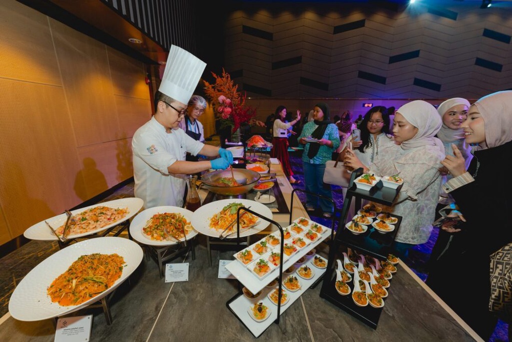 Chef preparing salads at a live station at Flavours of KLCC