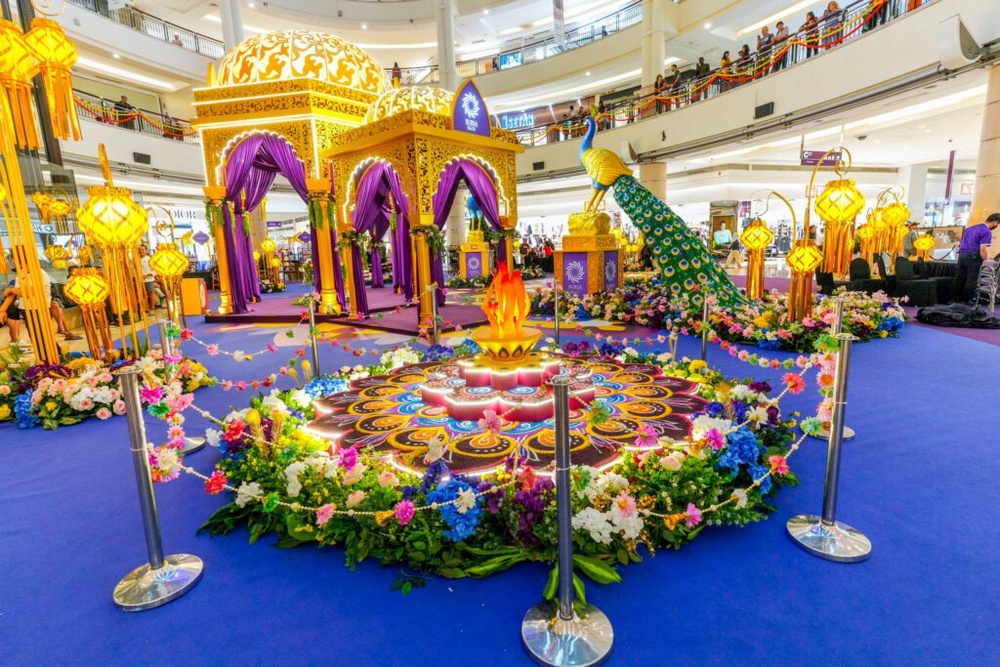 Illuminated kolam display with flame-shaped lamp at Suria KLCC for Deepavali