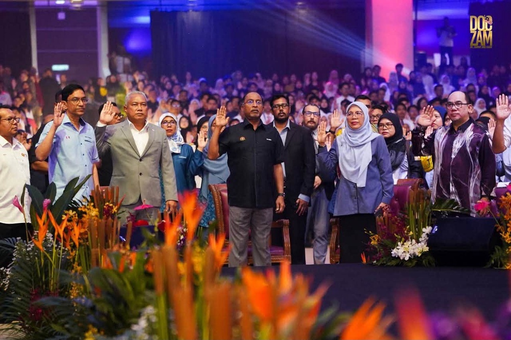 May be an image of one or more people, dais, crowd and text