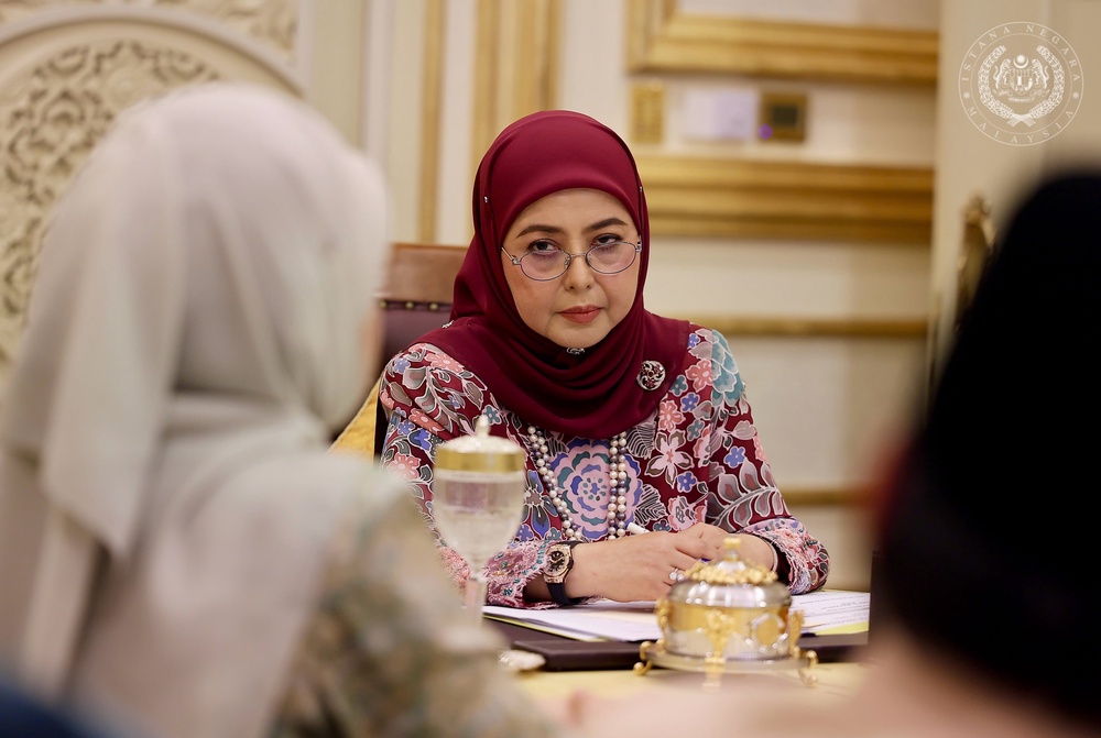 May be an image of one or more people, headscarf and text