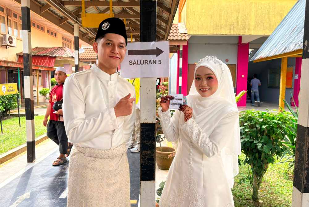 Image from: Newlyweds cast their votes after wedding in memorable Johor polls moment