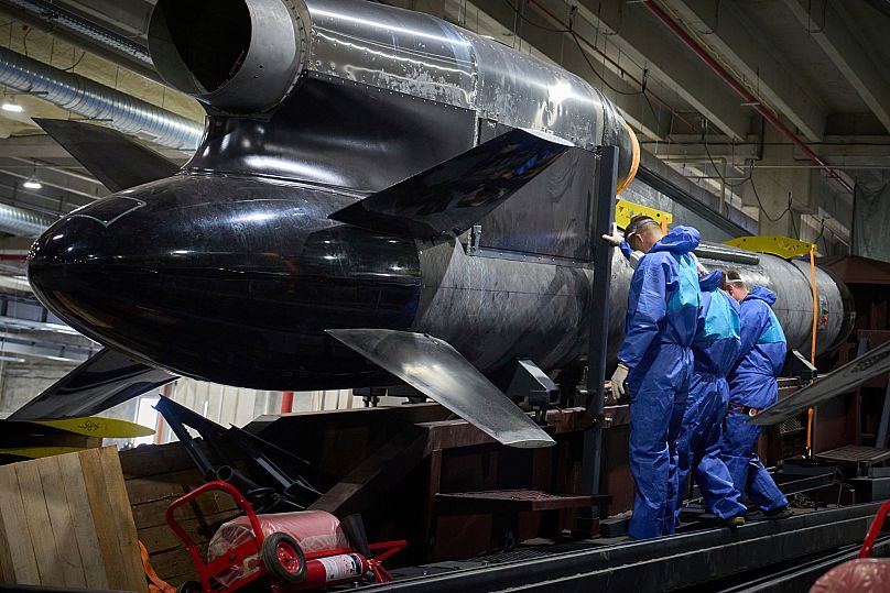  FILE - Workers inspect a Flamingo cruise missile at Fire Point's secret factory in Ukraine on Monday, Aug. 18, 2025.