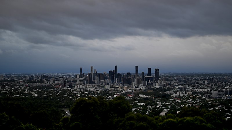 Brisbane pummelled by heavy rain, with hail possible across south-east