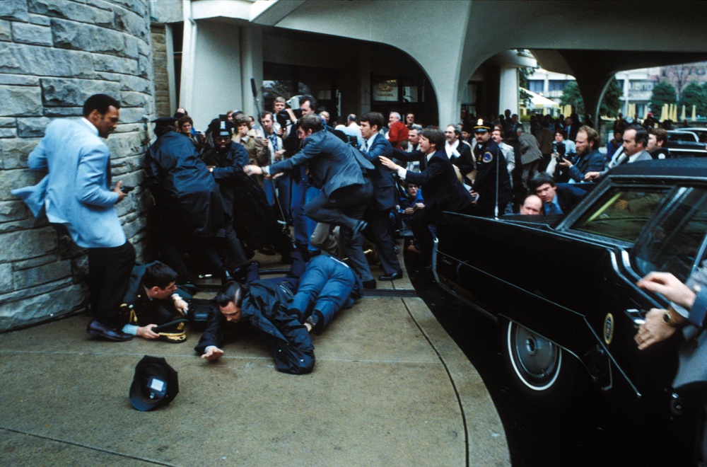 John Hinckley Jr is tackled to the ground by Secret Service agents after attempting to assassinate Ronald Reagan (Zuma/Shutterstock)