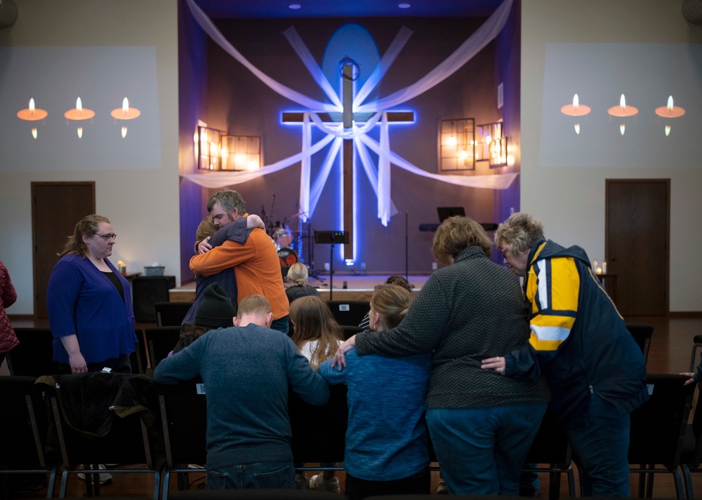 Relatives of Iliana “Lily” Peters comfort each other as they pray together at a vigil for the 10 year-old girl at Valley Vineyard Church in Chippewa Falls (AP)