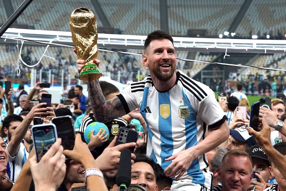 Argentina captain Lionel Messi was held aloft after World Cup triumph in 2022 (PA Wire)