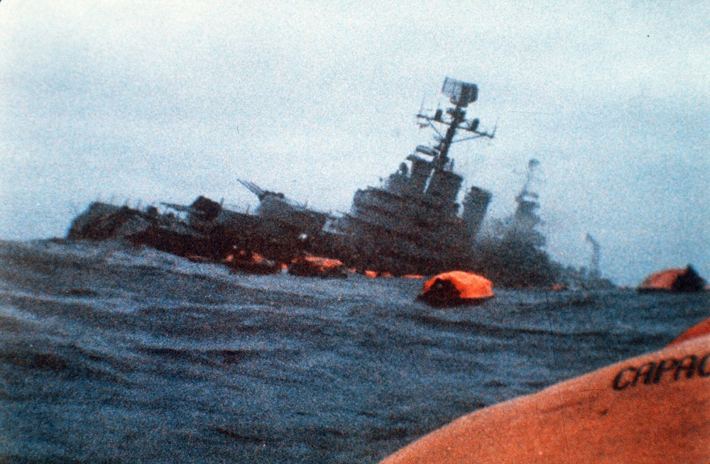 The Argentinian cruiser General Belgrano sinks amid orange life rafts holding survivors in the South Atlantic Ocean, May 1, 1982, after being torpedoed by the British Royal Navy during the Falklands War (AP)
