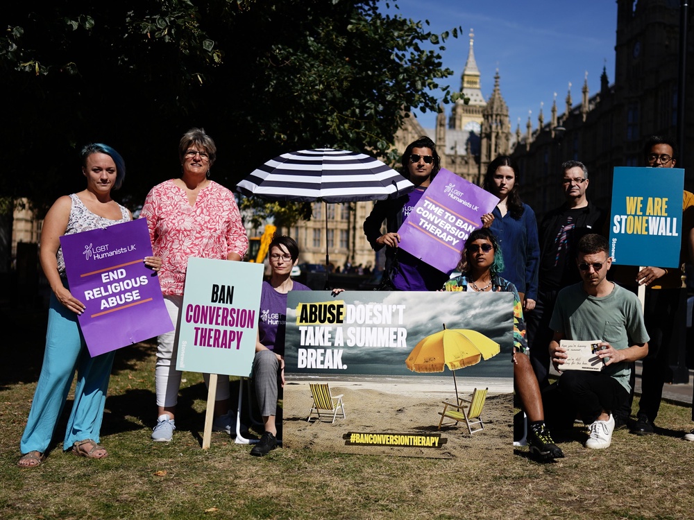Stonewall and other members of the Ban Conversion Therapy Coalition attend a protest outside Westminster in 2023 (PA)