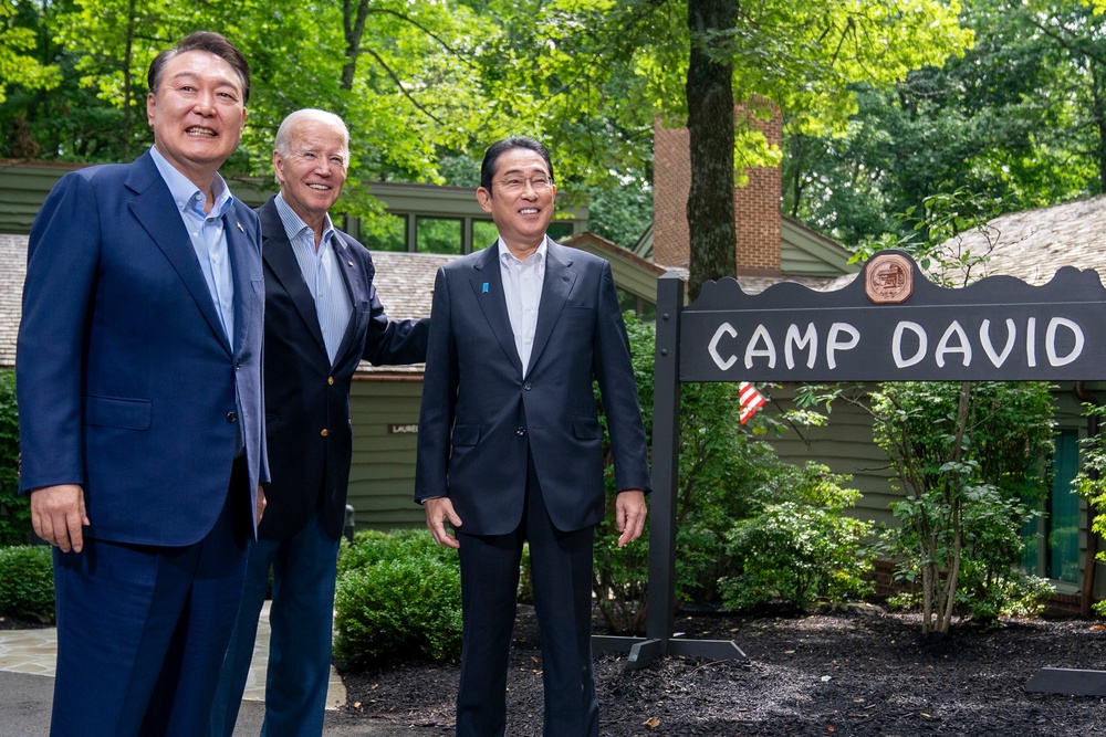 Former President Joe Biden, center, greets South Korea's President Yoon Suk Yeol, left, and Japan's Prime Minister Fumio Kishida, right, on Aug. 18, 2023, at Camp David (Copyright 2023 The Associated Press. All rights reserved)