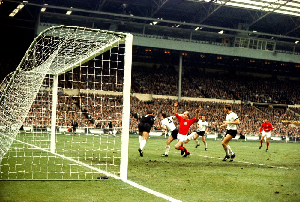 Franz Beckenbauer shepherds Bobby Charlton away from the ball (PA)