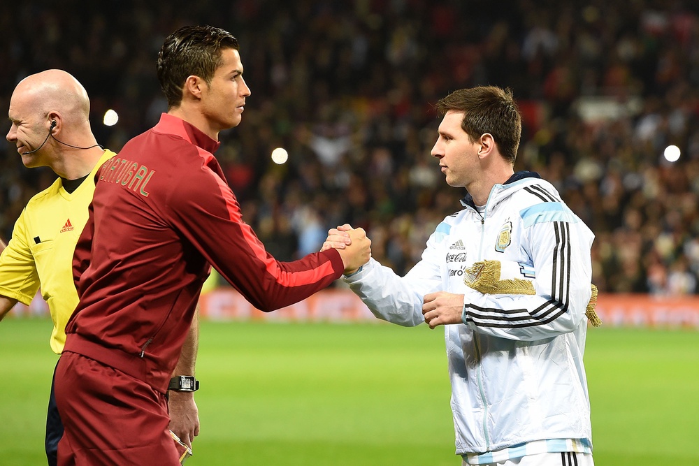 Cristiano Ronaldo and Lionel Messi during a 2014 international friendly at Old Trafford (PA)