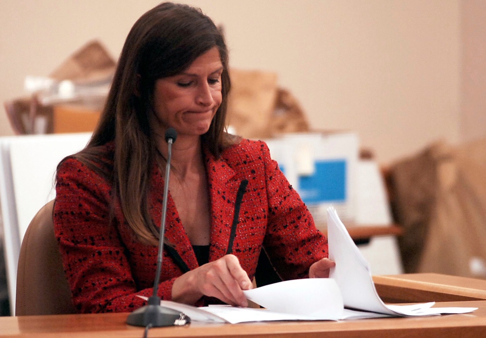 Woods, a laboratory agent for the Colorado Bureau of Investigations' Biological Science Section, looks through forms she filled out during her testimony at the James Whitler murder trail in Fort Collins Wednesday May 6, 2009