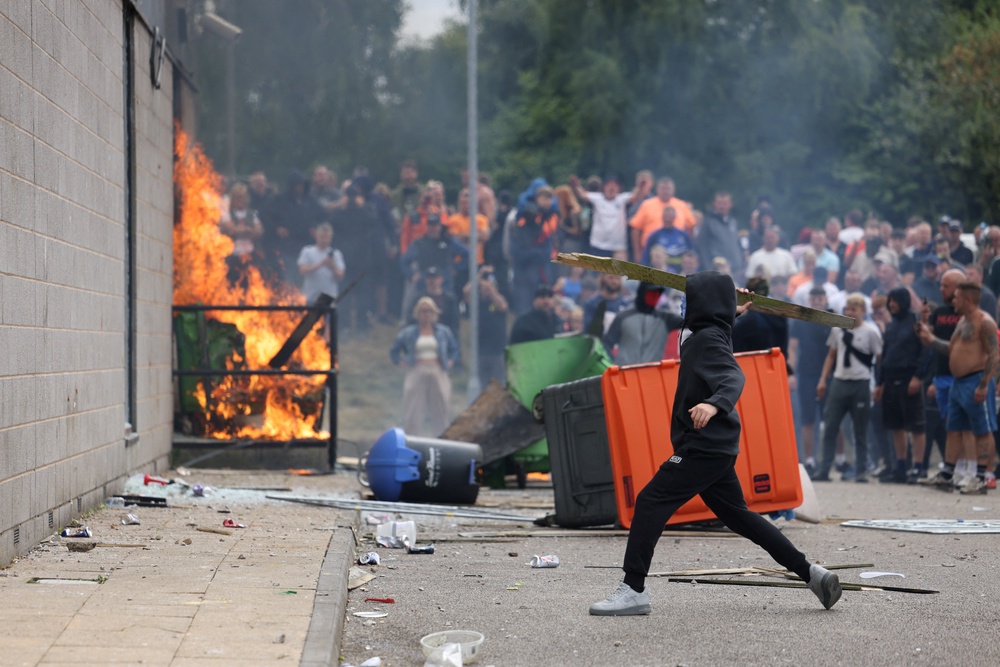 A far-right mob attacked and set fire to a Holiday Inn believed to be housing migrants in Rotherham (Reuters)