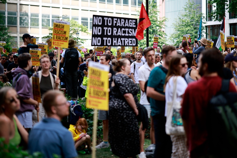 People hold anti-racism placards as they take part in a ‘Stop the Far-right’ demonstration (AFP via Getty Images)