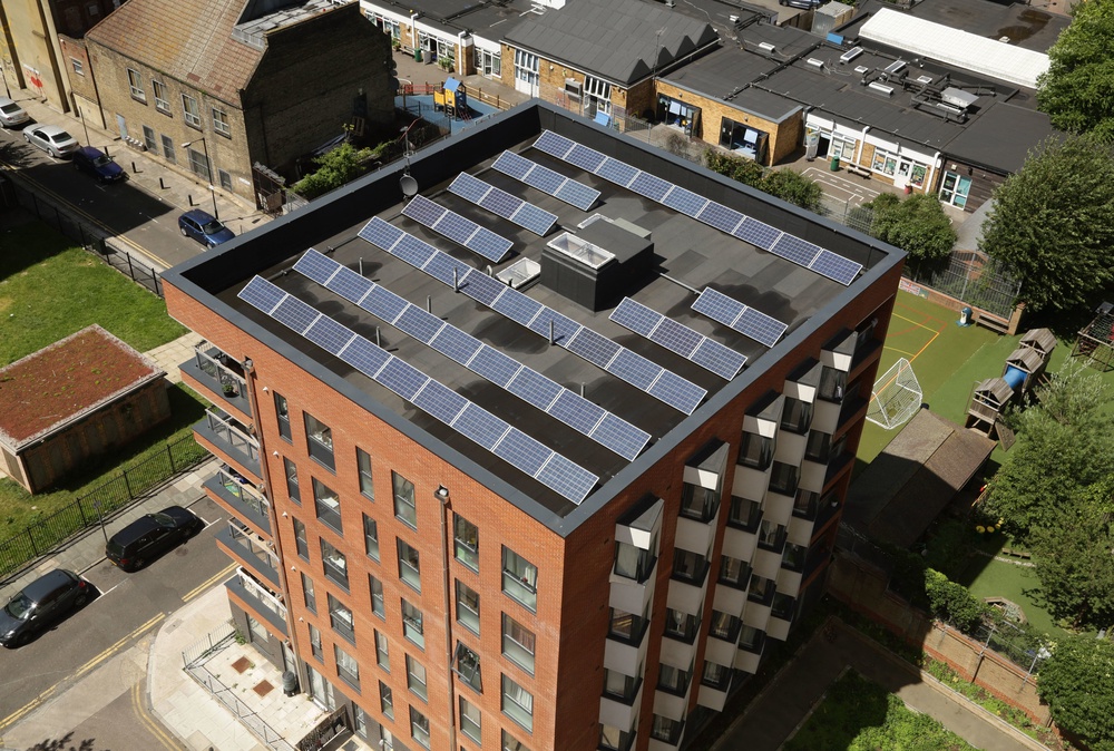 Solar panels on the roof of an apartment block in Bethnal Green, east London (PA)
