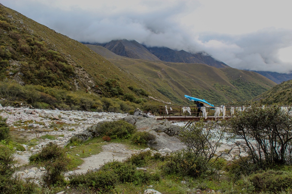 A Nepali porter carrying a door across a bridge in the Khumbu Valley (Rod Ardehali)